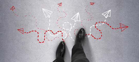 Top view of businessman feet on concrete ground with different arrows. Way, solution, direction and...