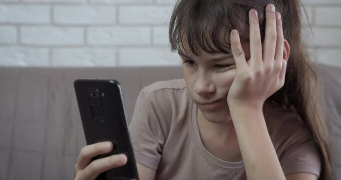 Cyber bullying message. An upset teenage girl after cyber bulling browsing in internet.