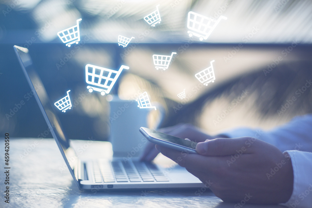 Poster close up of hands using laptop at desktop with coffee cup and abstract glowing cart icons on blurry 