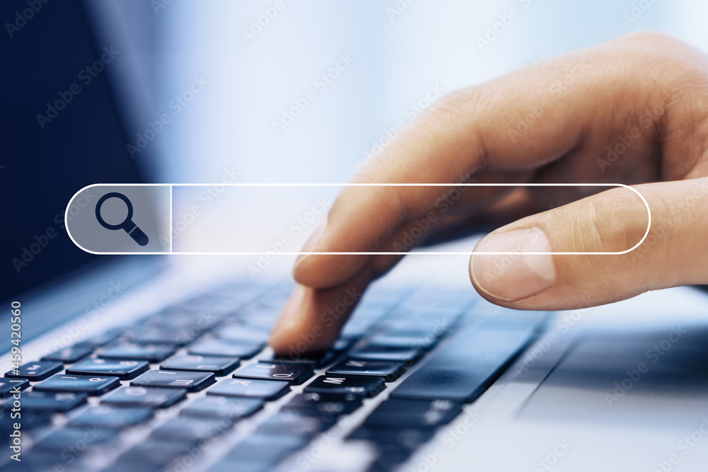 Aufkleber Close up of hand using laptop on blurry background with search bar. Web browser and seo concept.