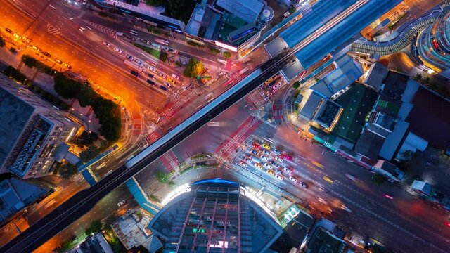 Time lapse of aerial view of bangkok intersection or junction with cars traffic, Bangkok Downtown. Thailand. Financial district in smart urban city and technology concept.
