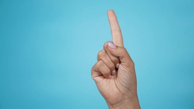 Close-up of isolated on blue adult female hand counting from 0 to 5. Woman shows fist fist, then one, two, three, four, five fingers. Manicured nails painted with beautiful pink polish. Math concept