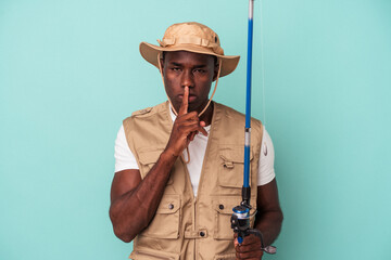 Young African American fisherman holding rod isolated on blue background keeping a secret or asking for silence.