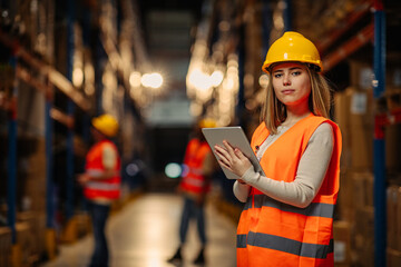 Warehouse female worker at her workplace.