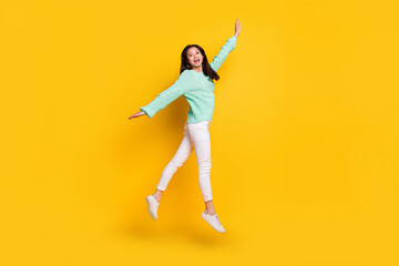 Fototapeta na wymiar Full length photo of cheerful young positive young woman jump up active lady isolated on yellow color background