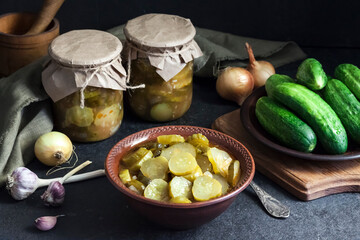 Pickled cucumber salad in a bowl and jars