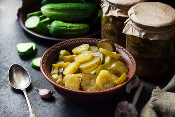 Pickled cucumber salad in a bowl and jars
