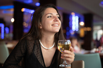 Happy woman with glass of white wine