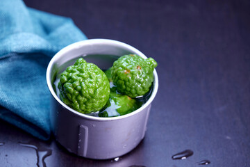 closeup bergamot or kaffir lime in the stainless bowl