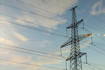 Telephone pole with cables under blue sky outdoors