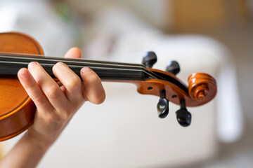 hands of a young young violinist music on the violin, horizontal