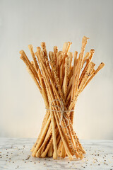 Delicious grissini sticks on white marble table