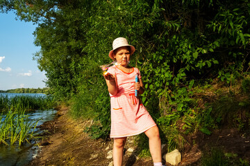 The girl blows bubbles, but the wind bothers her, and the bubbles quickly burst.