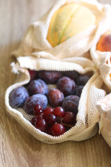 Reusable mesh bag filled with fresh fruit and vegetables. Selective focus.