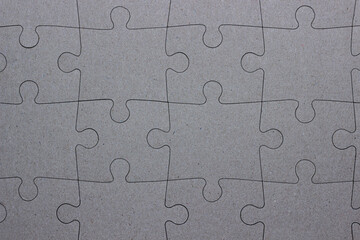 assembled puzzles on gray background, texture, place for text