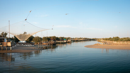 Fototapeta premium Landscape of fishing huts in the river with typical italian fishing machine, called 
