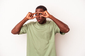 Young African American man isolated on white background keeping eyes opened to find a success opportunity.