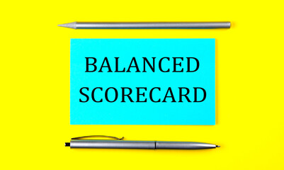 text BALANCED SCORECARD on the blue sticker on the yellow background