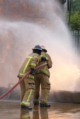 Naklejka premium fire-fighters fighting large industrial fire 