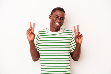 Young African American man isolated on white background showing victory sign and smiling broadly.