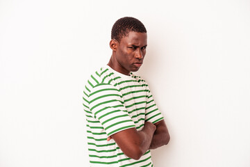 Fototapeta premium Young African American man isolated on white background frowning face in displeasure, keeps arms folded.