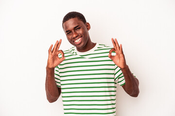 Young African American man isolated on white background cheerful and confident showing ok gesture.