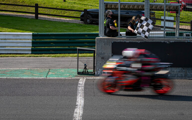 A shot of a racing motorbike as it circuits a track.
