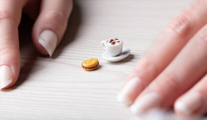 micro cappuccino and mini bisquit with hands
