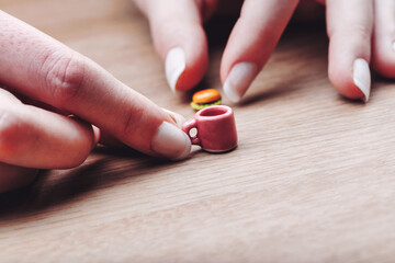 hands with mini food on a table