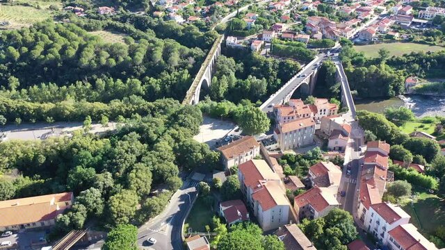 General view from drone of Ceret town on banks of river Tech in foothills of Pyrenees mountains in summer, France
