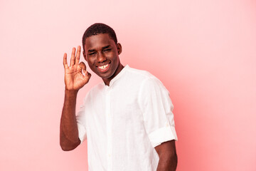 Fototapeta premium Young African American man isolated on pink background cheerful and confident showing ok gesture.