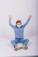 Little cute kid in a studio, wearing mask for protection, Coronavirus outbreak concept.