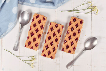 Rectangular slices of pie called 'Linzer Torte', a traditional Austrian shortcake pastry topped...