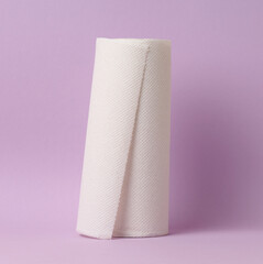 Soft paper towel on a purple background, disposable kitchen towel.