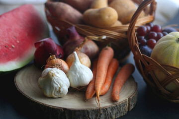 Various seasonal fruit and vegetable on dark background. Selective focus.