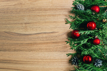 top view of a christmas wooden background decorated with branches of a christmas tree christmas toys pine cones