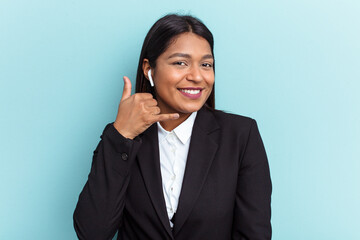 Young Venezuelan business woman isolated on blue background showing a mobile phone call gesture with fingers.