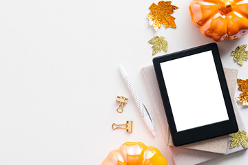 Autumn background with digital tablet ebook mockup, pumpkins, maple leaves on white table. Flat lay, top view. - Powered by Adobe