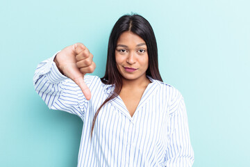 Young Venezuelan woman isolated on blue background showing thumb down, disappointment concept.