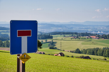 Shot of a dead end no through way sign on a country road with Ruswiler Berg in the background