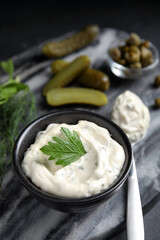 Tasty tartar sauce on marble board, closeup