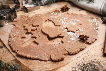 Making Christmas cookies. Raw dough and cutters on wooden table