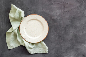 Top view of empty plate on napkin. Table setting for dinner