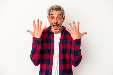 Middle age caucasian man isolated on white background  showing number ten with hands.