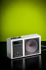 Old fashioned white radio receiver on a green background
