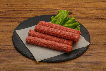 Raw beef sausages with spices