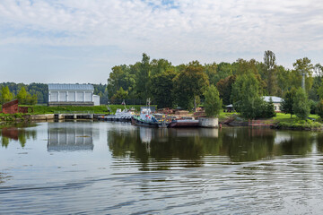 Fototapeta premium Weathered dock for boats and small ships on the banks of a calm river