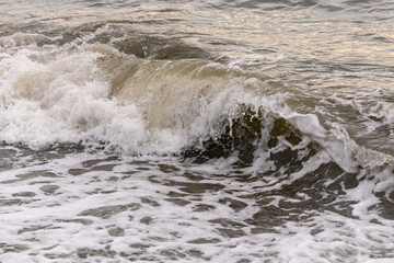 white sea foam near the shore close-up, waves