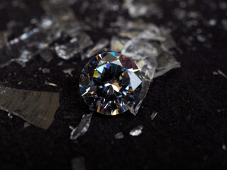 Close up shot of roud cut zircon zirconia gems with broken glass surrounded. Shoot on a black...