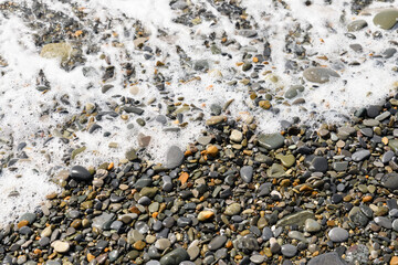 Pebble beach .Sea wave near the shore.